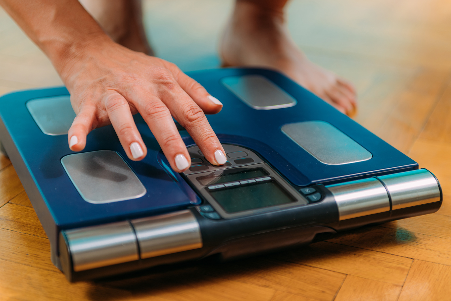 Hand Tapping on a Weighing Scale 